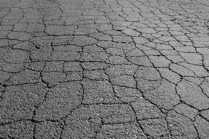 Image shows asphalt pavement exhibiting severe alligator cracking.